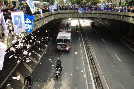 Pessoas com bandeiras do Brasil, do PSDB e do Santos Futebol Clube, clube do prefeito, se concentram no viaduto do Ch