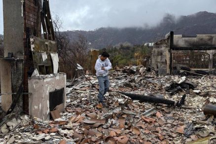 Castellani retorna  casa destruda pelo fogo em Mullholand Drive, Los Angeles: lareira foi a foi a nica parte do imvel que resistiy s chamas 