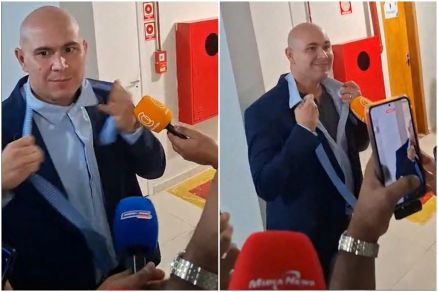 O prefeito Abilio Brunini tirando o terno com o qual compareceu  Cmara
