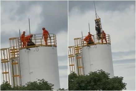 Equipe do Ciopaer auxilia no resgate dos trabalhadores no topo da caixa d'gua, a aproximadamente 30 metros do solo